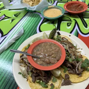 Chips, salsa, queso, street tacos and beans.