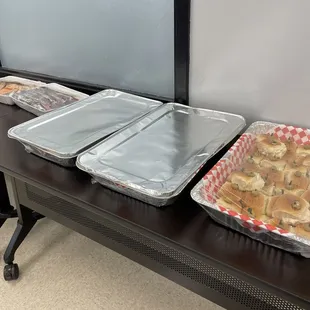 Chicken salad mini-wiches along with quarter sized Reuben sandwiches and club sandwiches; packaged brownies and cookies.