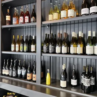 a shelf full of bottles of wine