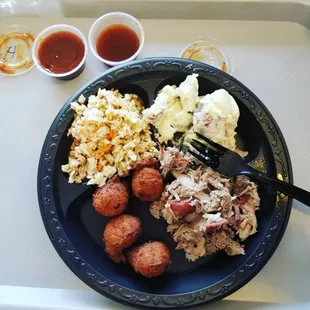 Small BBQ pork plate with potatoe salad and red slaw. It comes with hush puppies too!