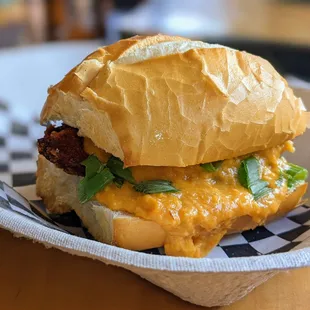 Chicken Milanesa Sandwich. $8. Panko-fried chicken topped w/ mild cream corn sauce and green onions, served on fresh-baked Brazilian bread.