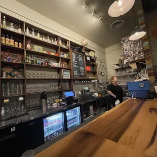 a woman behind the bar at a restaurant