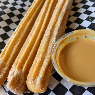 Churros. 3 for $6.50. Fried dough filled with Bavarian cream and served with dolce de leche.