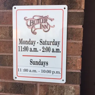 a sign on a brick wall