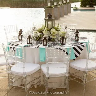 Timeless elegance with the use of clear chiavari chairs.  Nicely paired with black and white with a hint of color.  Simply stunning!