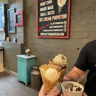 two people holding ice cream cones