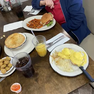 Eggs Benedict w/ hash browns, Coke, Juice, Fried Okra, Pot Pie, and Chicken Sandwich w/ potato fries
