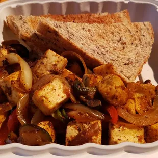Tofu scramble ($11), vegan by default. Nicely seared &amp; seasoned tofu. Great homemade bread. Wish they had a vegan sausage or bacon.