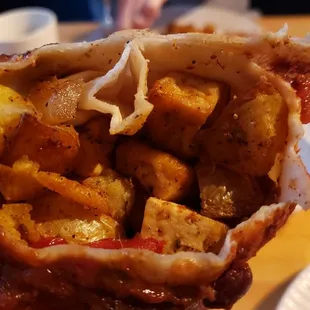 Interior of tofu burrito ($12), vegan by default. Pieces of tofu &amp; potato were too big &amp; under-seasoned.