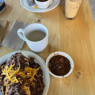 Breakfast burrito, one with chili on the side.