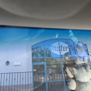 the reflection of a person in the window