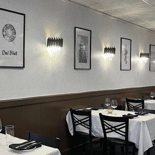 tables and chairs with white tablecloths