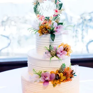 Butter+Cream three-tier wedding cake with flowers by Olivia&apos;s Mum and cake topper from Etsy