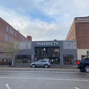 cars parked in front of the market