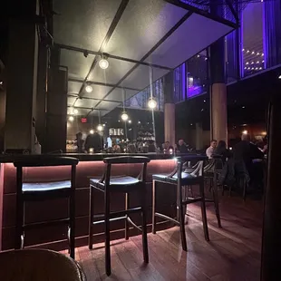a view of a bar with purple lighting
