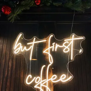 a neon sign that says but first coffee