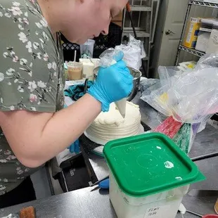 a woman decorating a cake