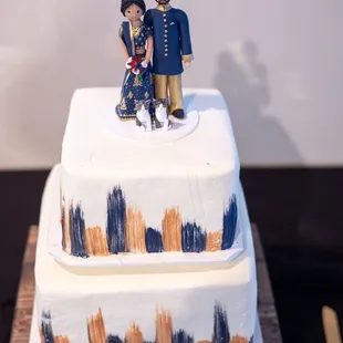a couple on top of a wedding cake
