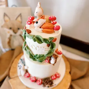 a three tiered cake decorated with animals