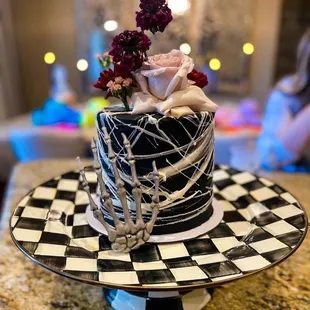 a black and white cake with flowers on top