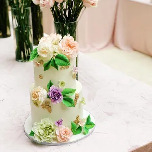 a three tiered cake decorated with flowers