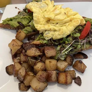 Avocado toast with scrambled egg and hash browns.