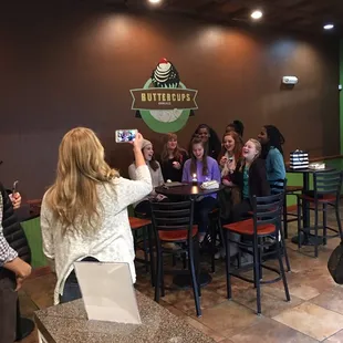 a woman taking a picture of a group of people
