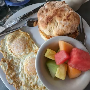 Two egg breakfast (over easy) with a biscuit and fruit