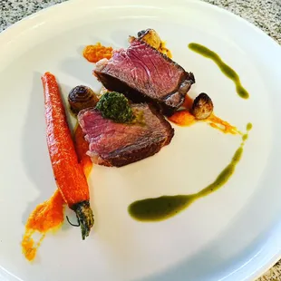 Carrot purée-butter poached organic carrot- caramelized pear onions - Prime New York steak - gremolata topping.