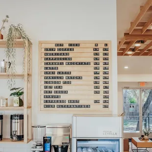 a coffee shop with a menu on the wall