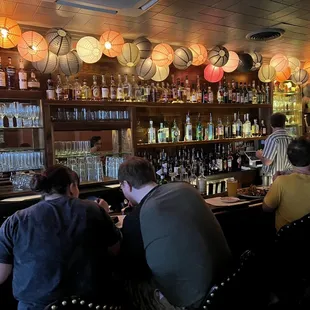 a group of people sitting at a bar
