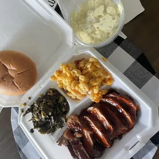 The chicken dinner with Mac and cheese, Greens, Potato Salad.