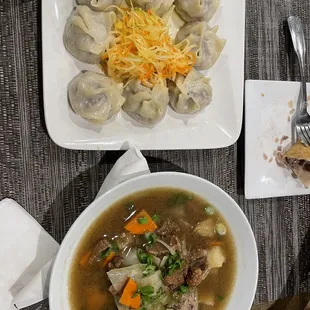 Dumplings and soup with clear glass noodles, potatos, and meat