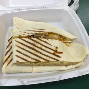 a burrito in a styrofoam container