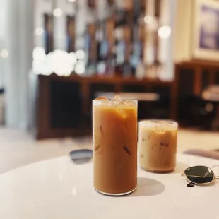 two glasses of iced coffee on a table