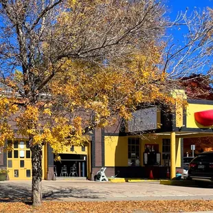 a black car parked in front of a yellow building