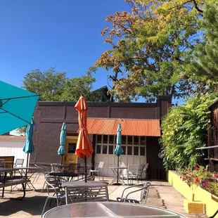 a patio with tables and umbrellas