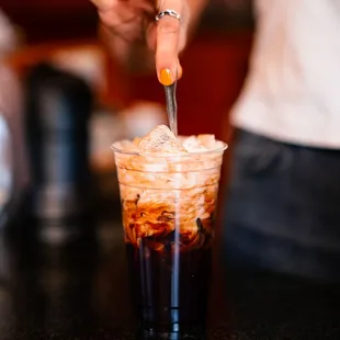 Making a Bean2Bean Cold Brew with oat milk at Buzz Cafe