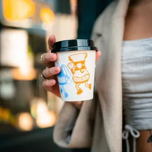 a woman holding a cup of coffee