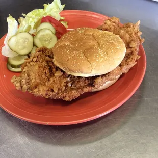 a fried chicken sandwich and a side salad
