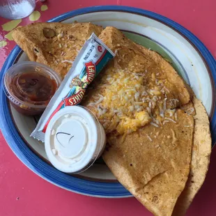 The buzzard dilla is served with salsa, sour cream &amp; white sauce