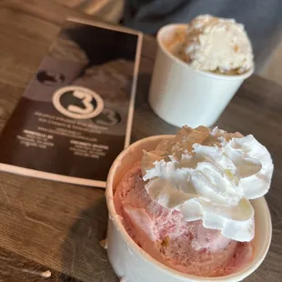 a cup of ice cream with whipped cream on top