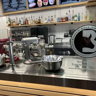 a counter with bowls and mixers