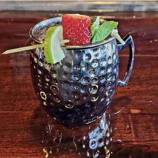 a watermelon drink in a metal mug