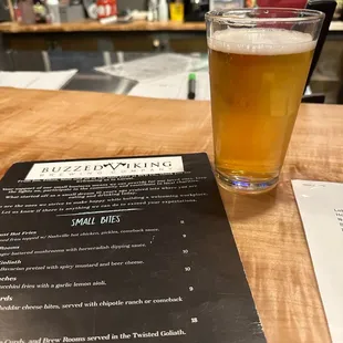 a glass of beer and menu