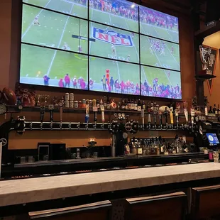 a sports bar with a large screen