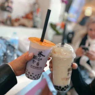 a woman holding a cup of boba tea