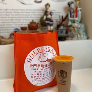 a cup of coffee next to a bag of coffee