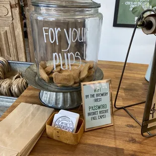a glass jar with a sign that says for you pugs