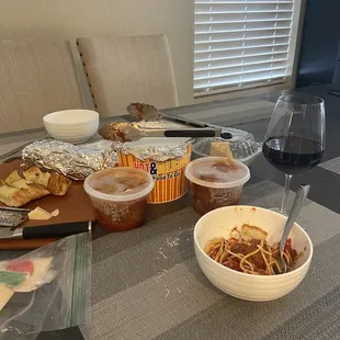 a table with food and a glass of wine